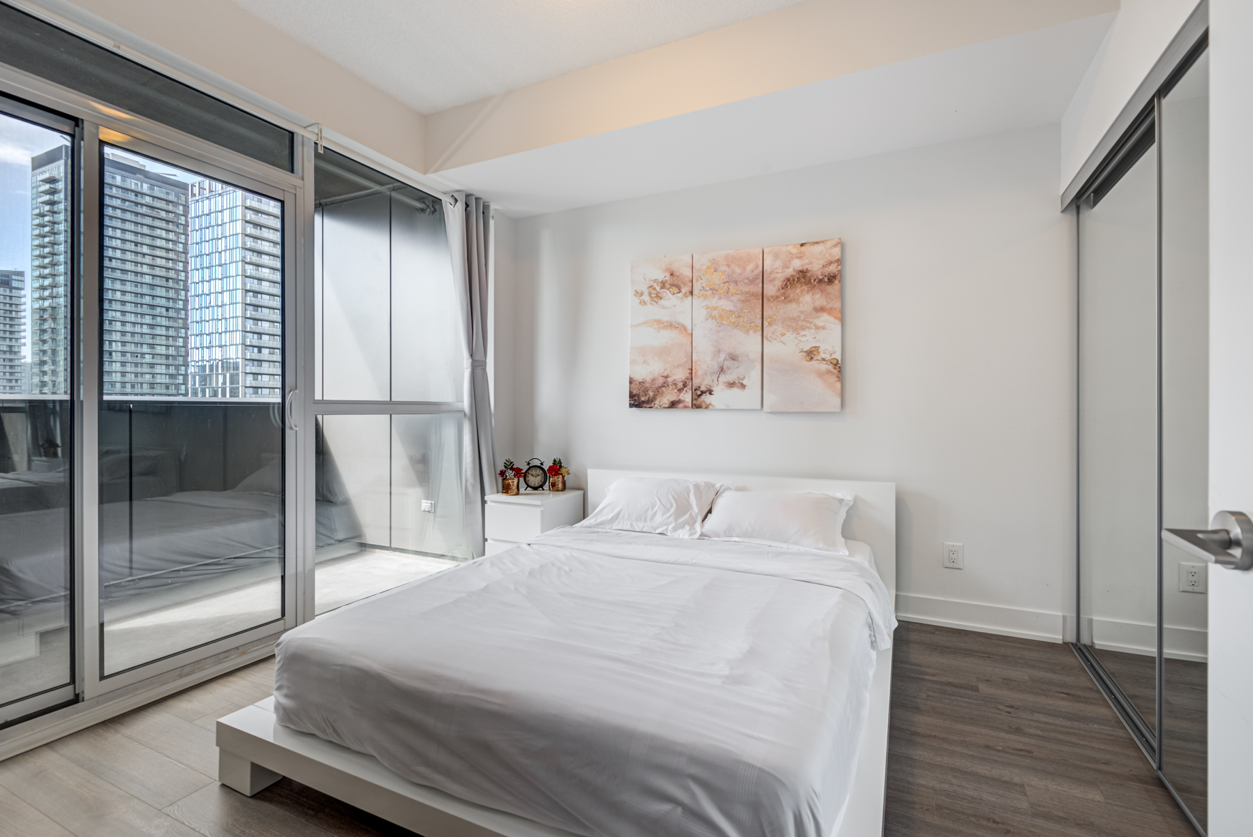 318 Richmond Unit 2607 large master bedroom with bed and balcony access.