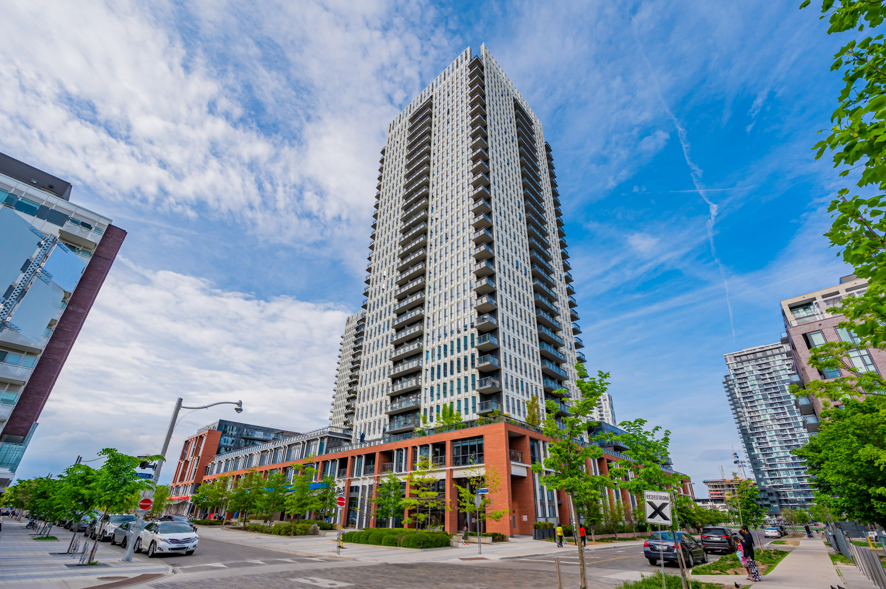 Across the street view of One Park Place South Tower condo surrounded by lush trees.