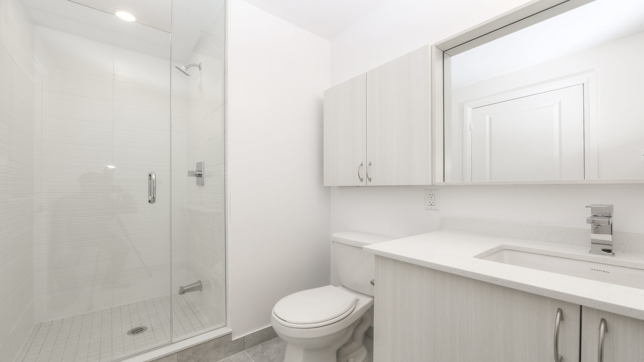 Image of master bath and shower, sink and mirror.