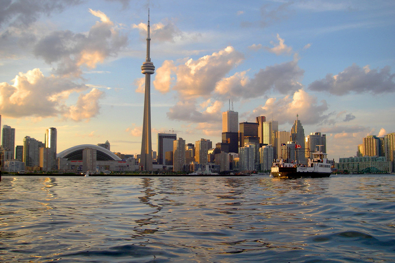 Photo of Toronto as seen from Lake Ontario. And, first of all, also, another, furthermore, finally, in addition because, so, due to, while, since, and therefore.