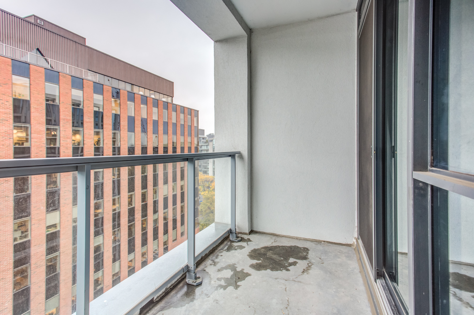 Balcony of 39 Brant St Unit 918, Brant Park Lofts, with glass-panels.