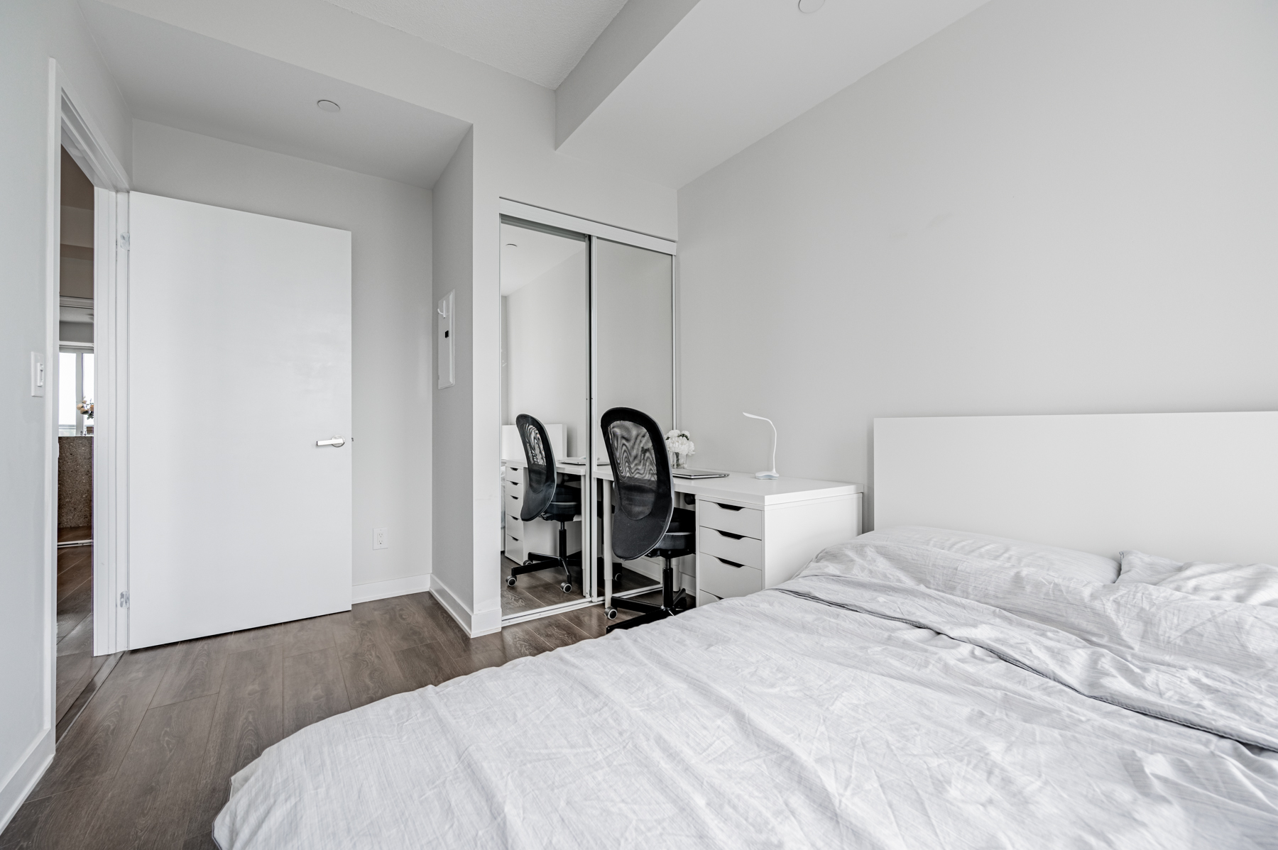 Condo bedroom with mirror door closet – 55 Regent Park Blvd # 1210.