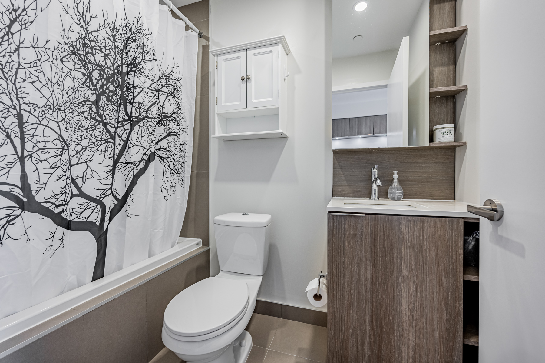 4-piece bath with porcelain floors and quartz counter – 55 Regent Park Blvd Unit 1210.