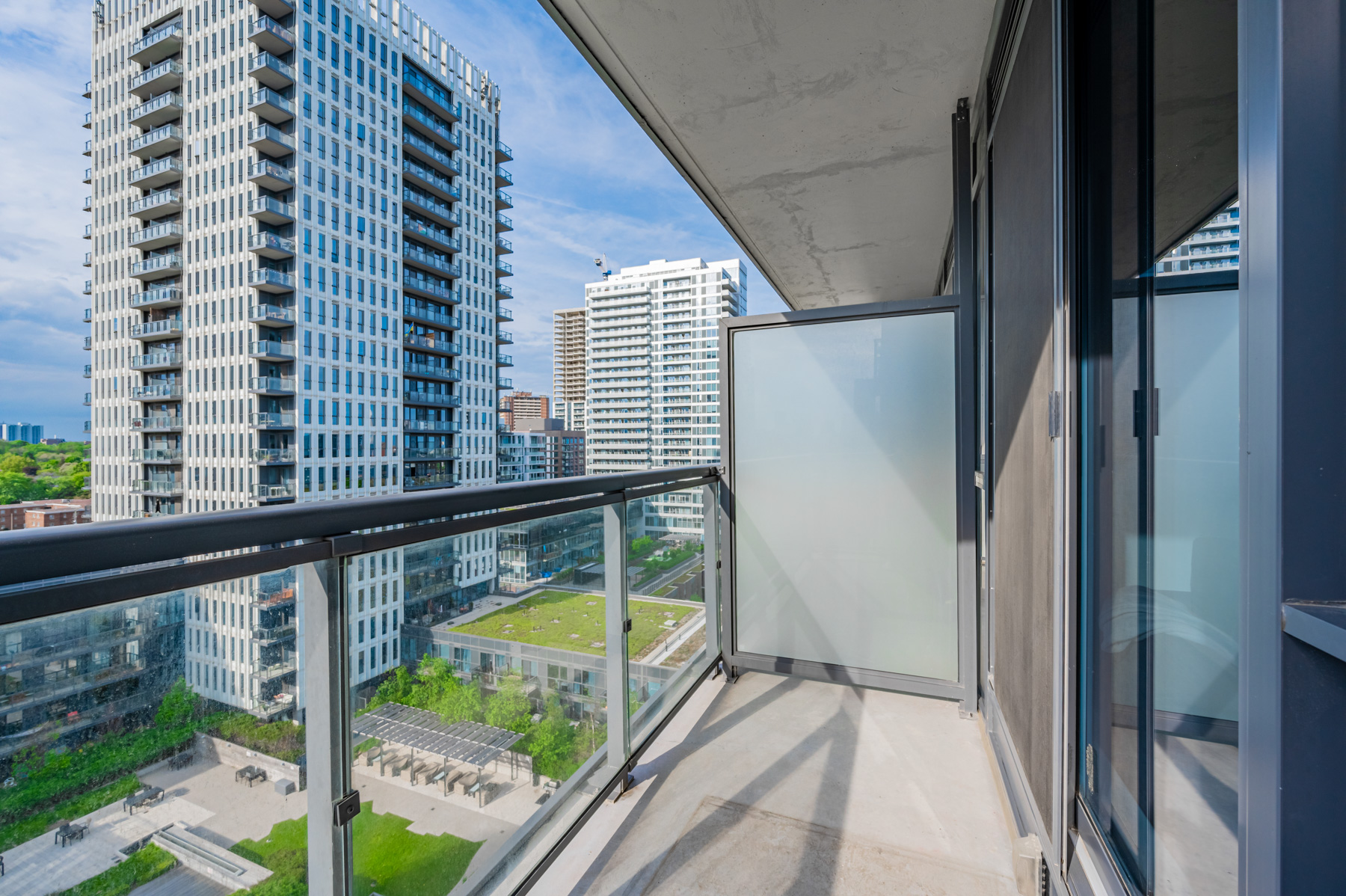 Condo balcony with opaque divider.