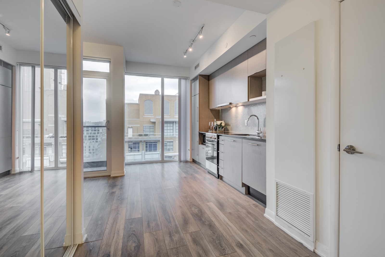 1st look at the penthouse suite with brown laminate floors and big windows at PH 101.