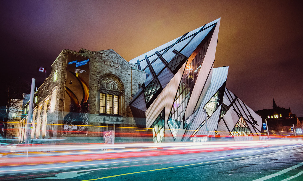 Royal Ontario Museum at night with traffic light trails.