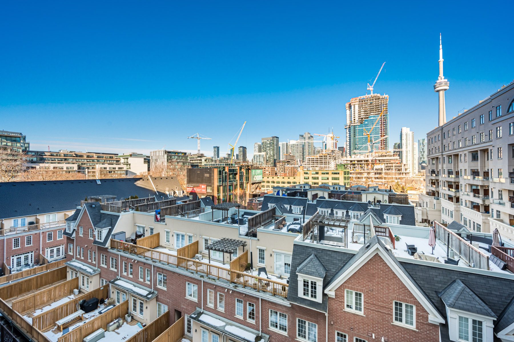 Houses in foreground; condo construction in background.