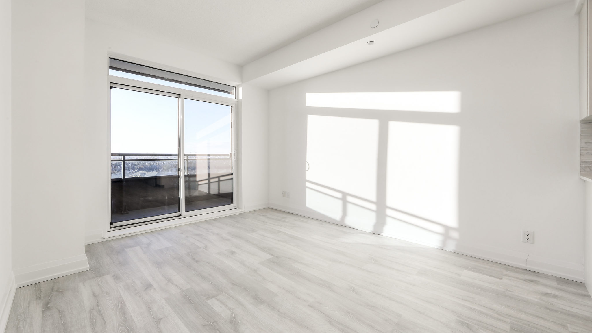 Picture of living room and glass doors. We also see so much sunlight pouring into the room.