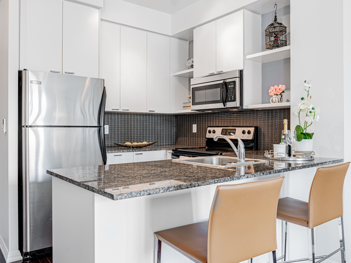 Condo kitchen with gray, blacks and silver aesthetic.