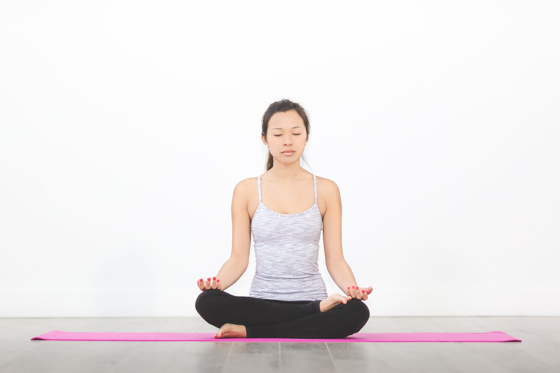 Image depicting woman practicing Yoga and meditation on pink Yoga mat