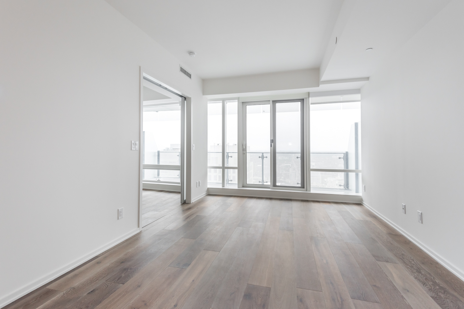 Photo showing large windows, screens, white walls, and so many other highlights of 1 Bloor. It seems like, maybe, probably, almost most of all, most noteworthy, and being a Toronto real-estate agent is especially relevant.