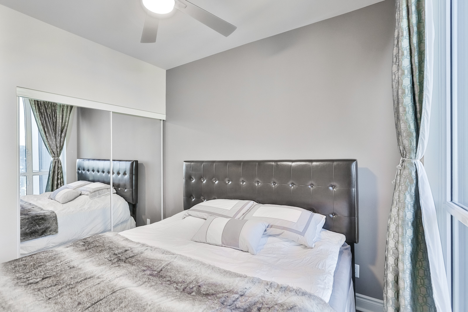 Picture shows 28 Ted Rogers Way closet and ceiling-fan. Also, we see so much use of grays and whites. It's rather striking. Furthermore, the view opposite is also amazing.