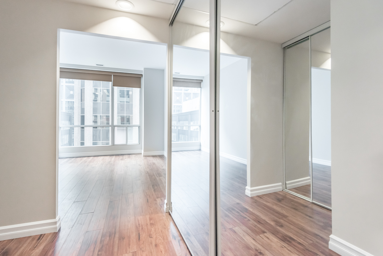 View of bedroom from another angle. The floors are so bright and glossy.