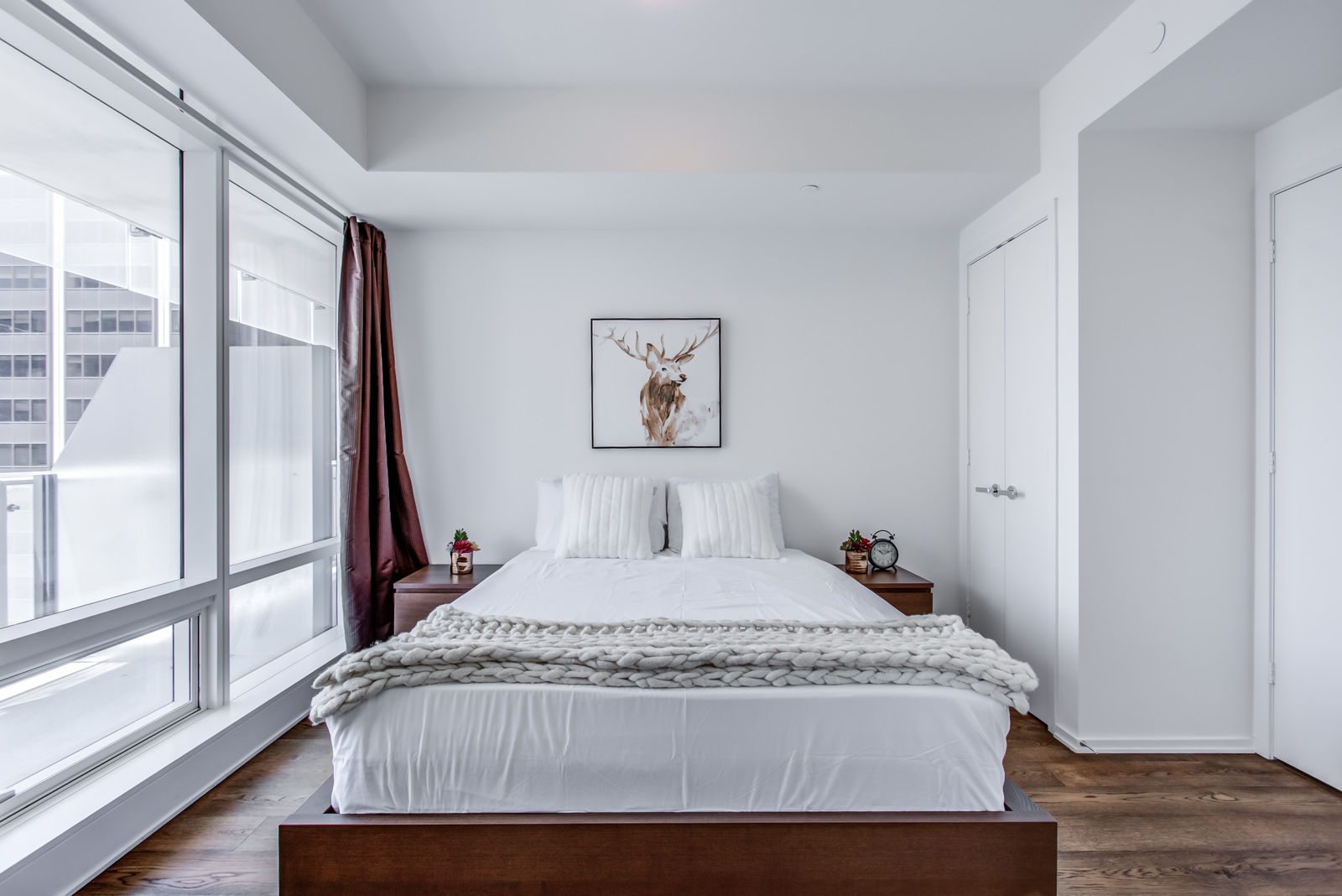 Master bedroom and bed of 1 Bloor St E Unit 3408.