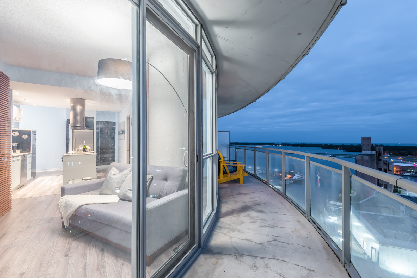 Pic of balcony at night and also the condo lights. We see the lovely curve and lake below.