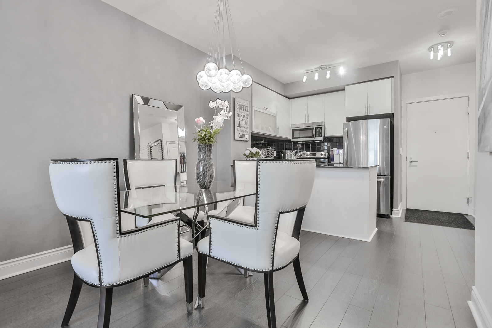 Photo of 28 Ted Rogers Way dining room with rather gorgeous halogen lamps. Everything matching because of the gray and white and silver colours.