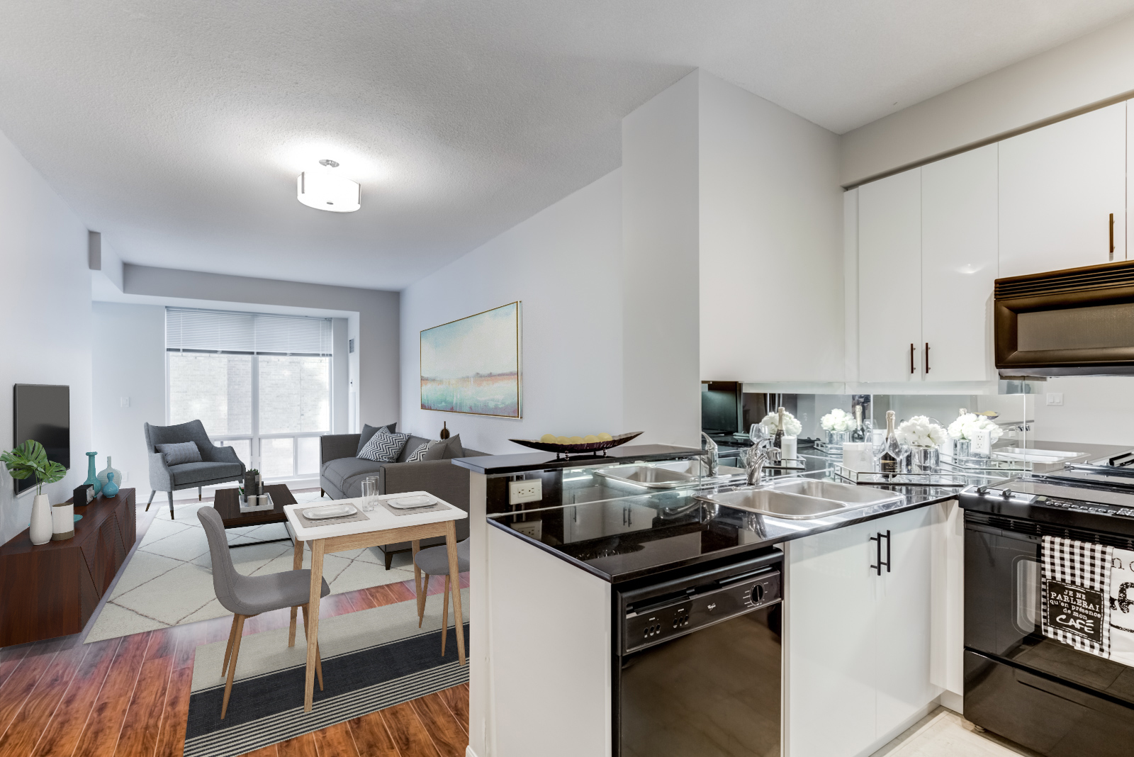 View of living and dining room of 300 Bloor St E Unit 1809 from kitchen.