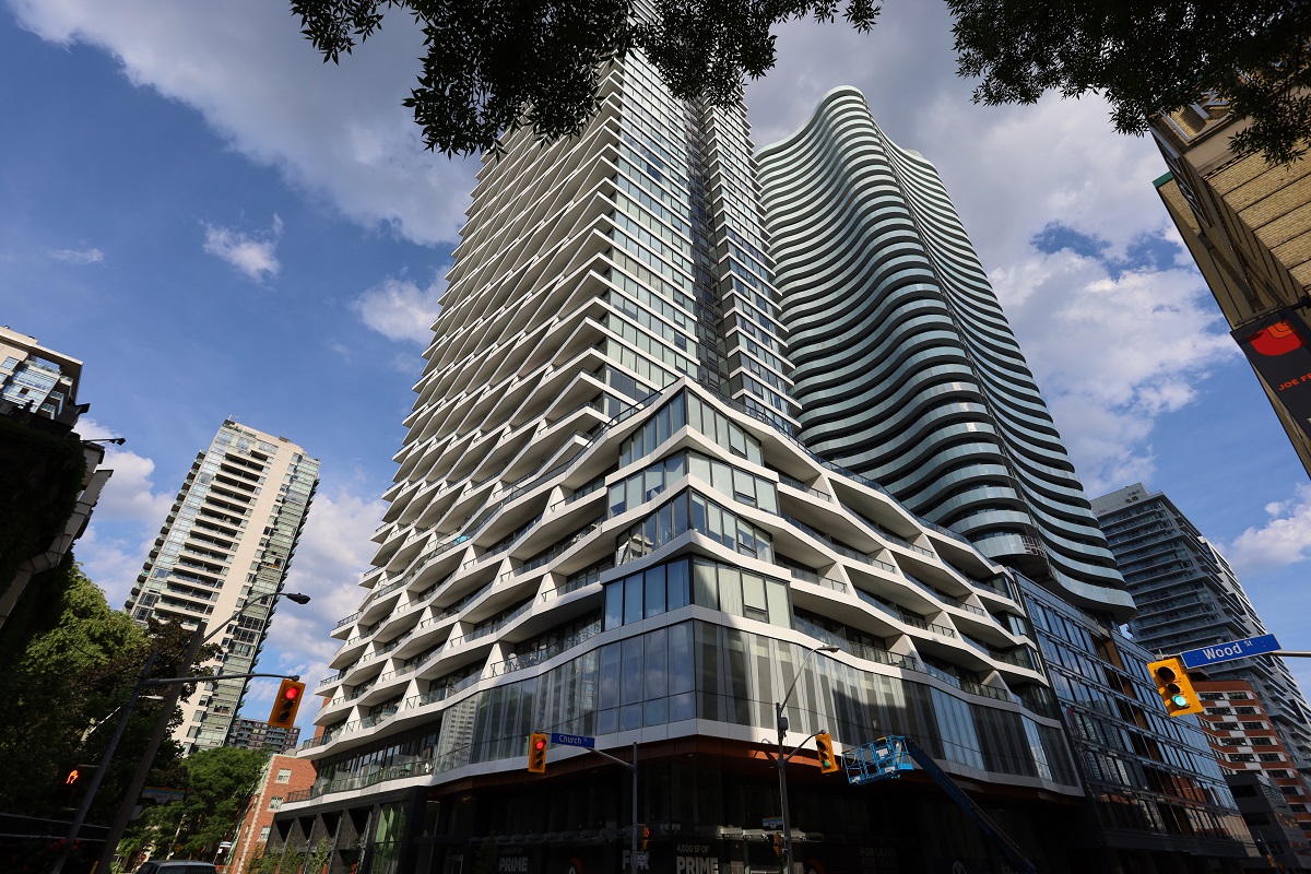 Street view of 403 Church St, an ultra-modern condo with a bold geometric facade and wavy lines.