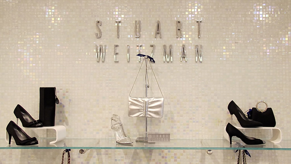 Stuart Weitzman Store display with women's shoes and purses.