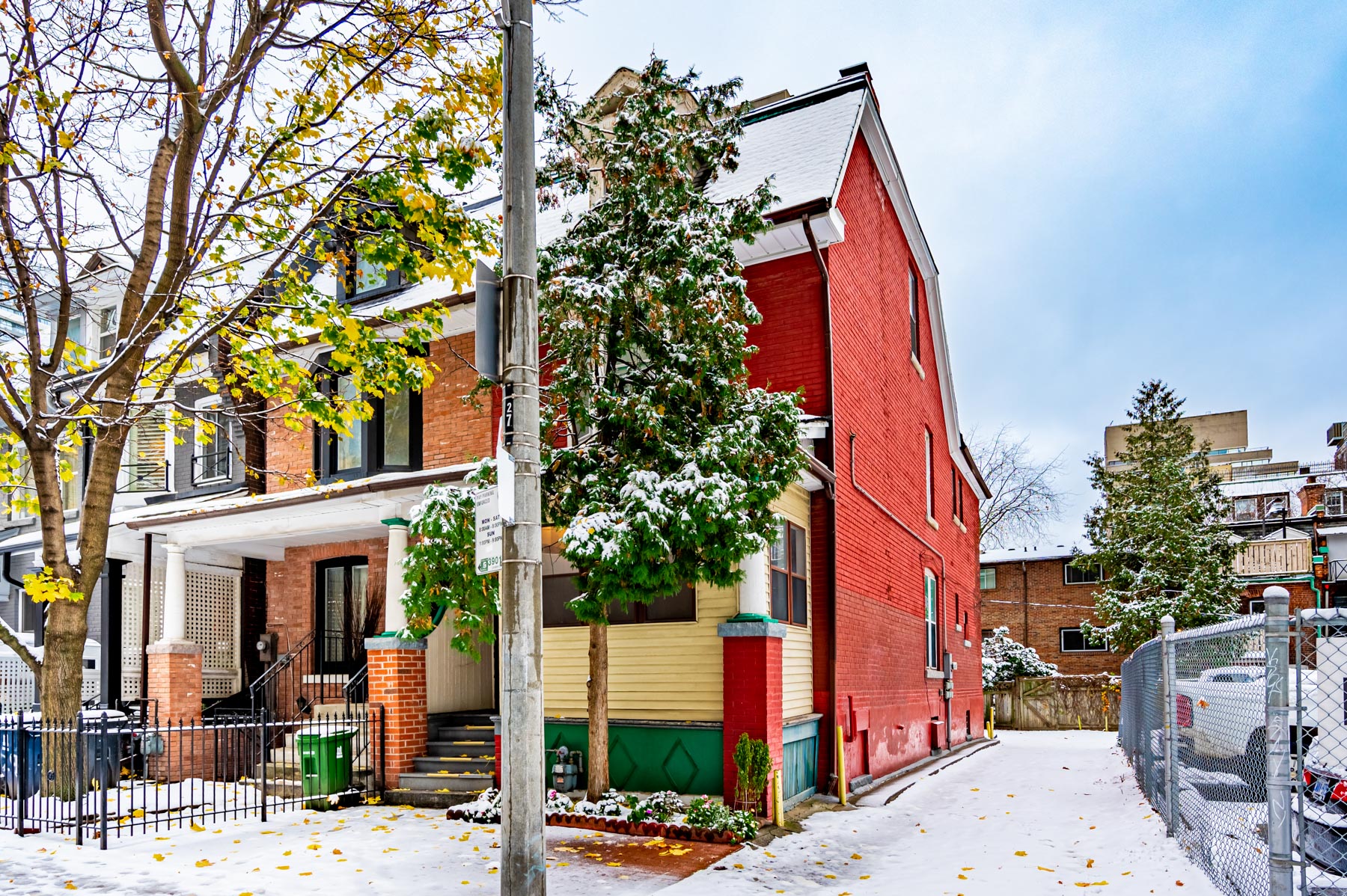 Red-brick side of 27 Granby St with metal fencing.