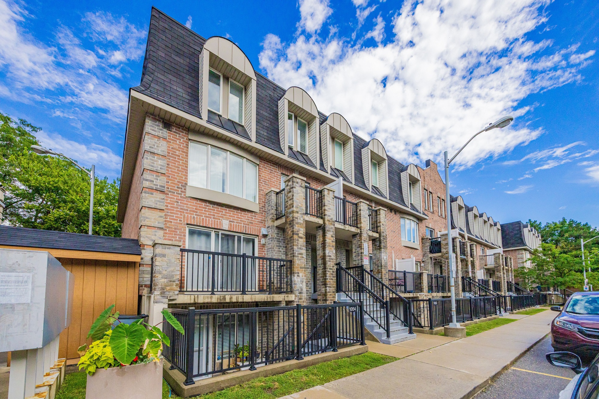 View of lush trees and blue skies outside 95 George Appleton Way.