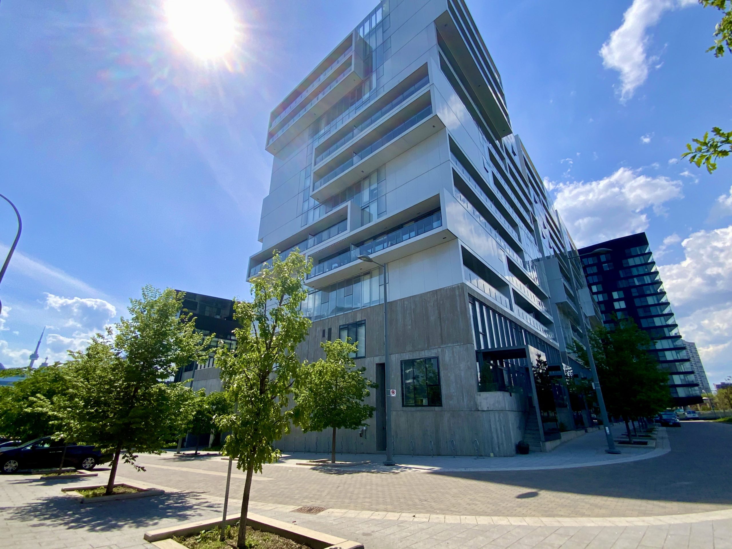 River City 2 condominium with wide sidewalks and trees.