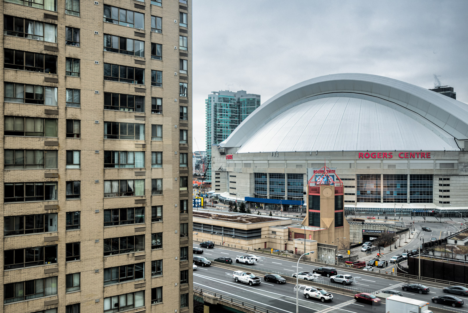 White-domed Rogers Centre, busy highway and buildings close to Harbourpoint II.