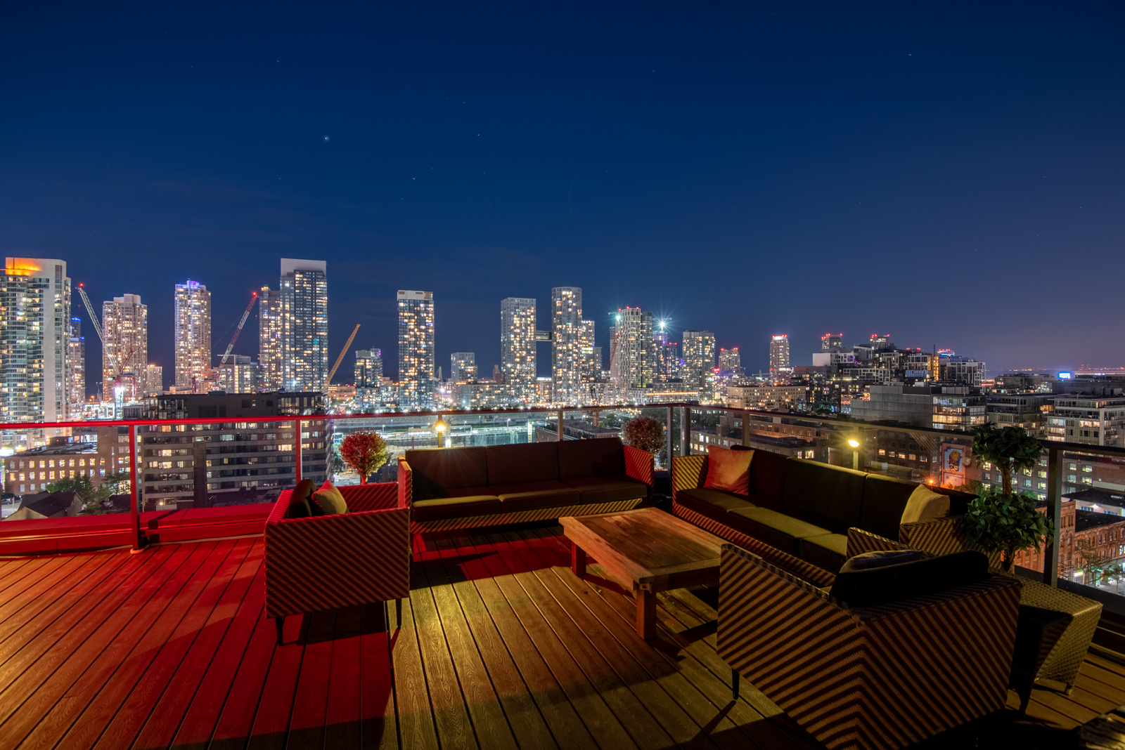 Night view of terrace and deck and Toronto from Victory Lofts Penthouse Suite in 478 King St W Toronto.