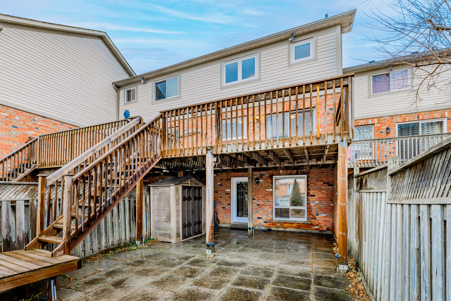 View of 77 Schouten Cres backyard and massive wooden deck.