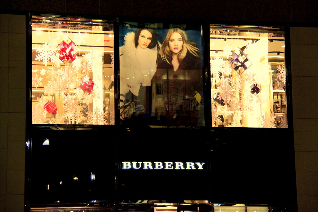 Burberry storefront with window display and model poster.