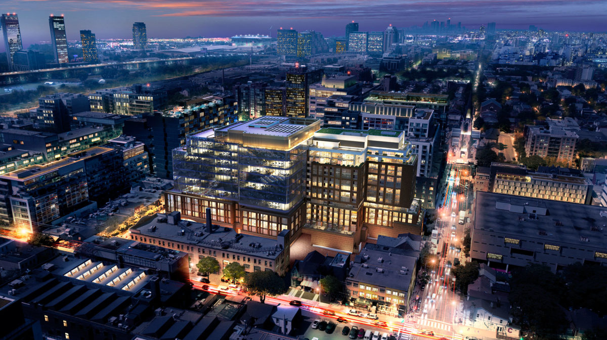 Sky view of King West and Kingly Residences at night with buildings in shadow and bright car lights.