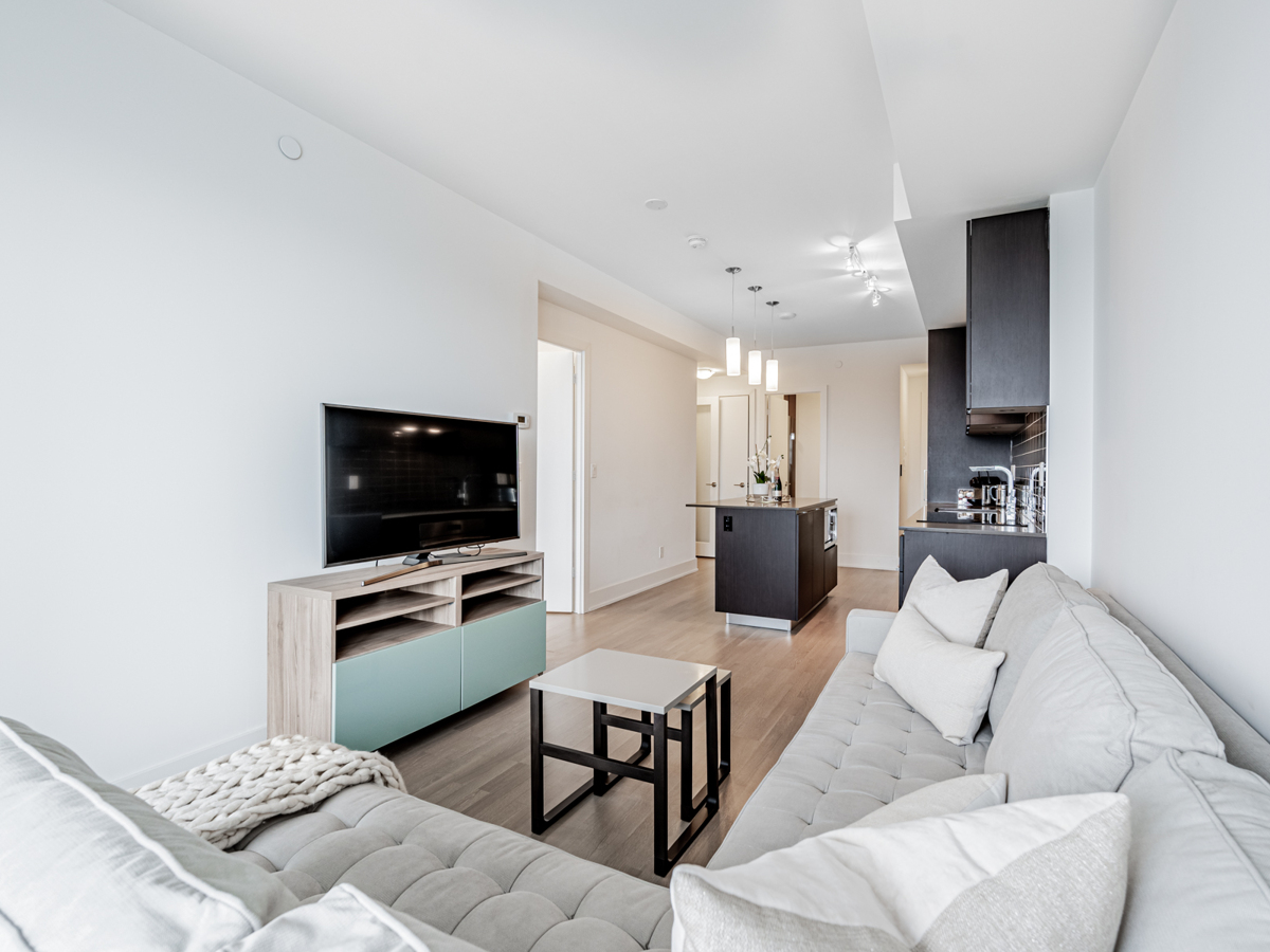 View of 200 Bloor St W Unit 2405 dining room and kitchen from living room.