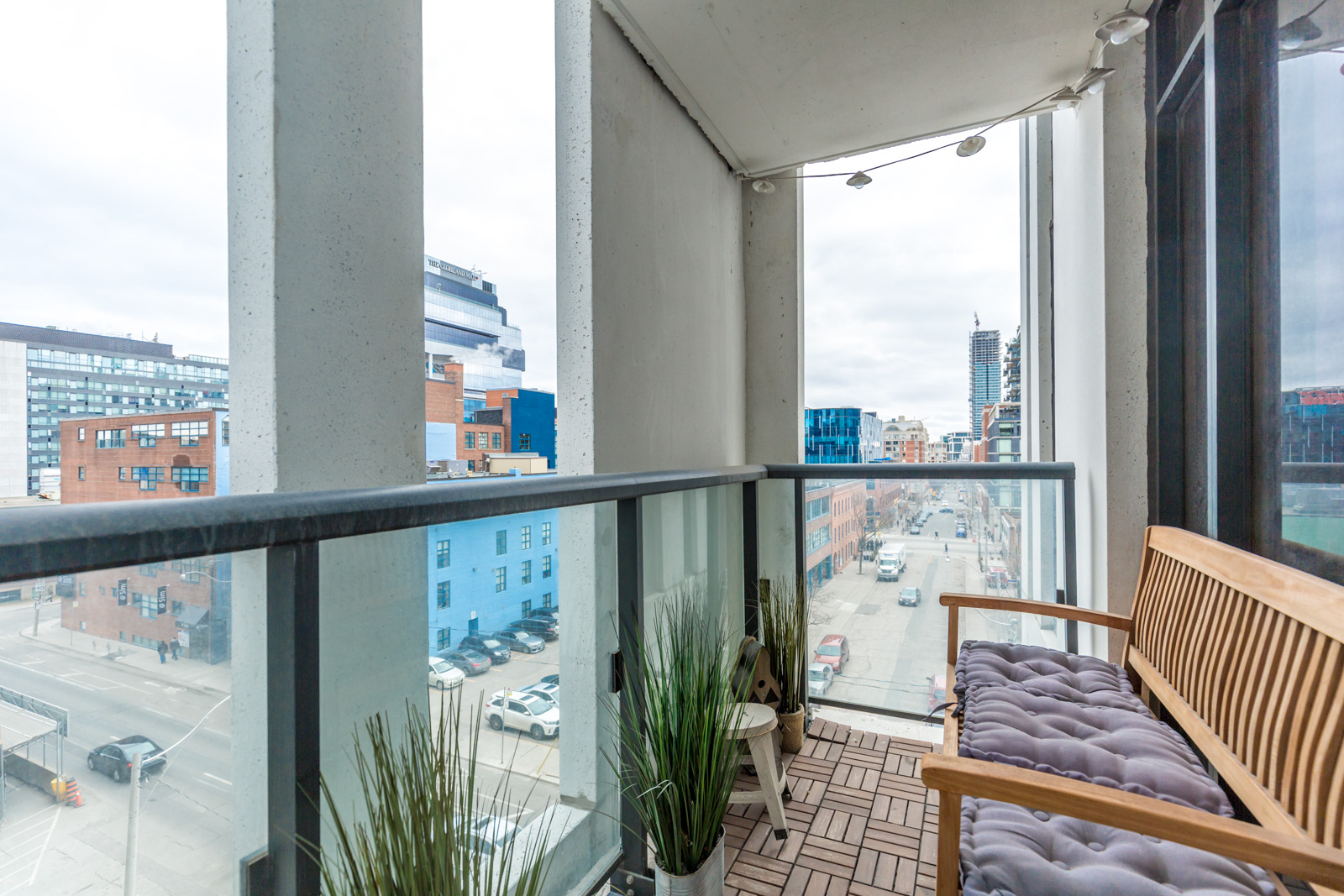 Photo shows balcony and city below