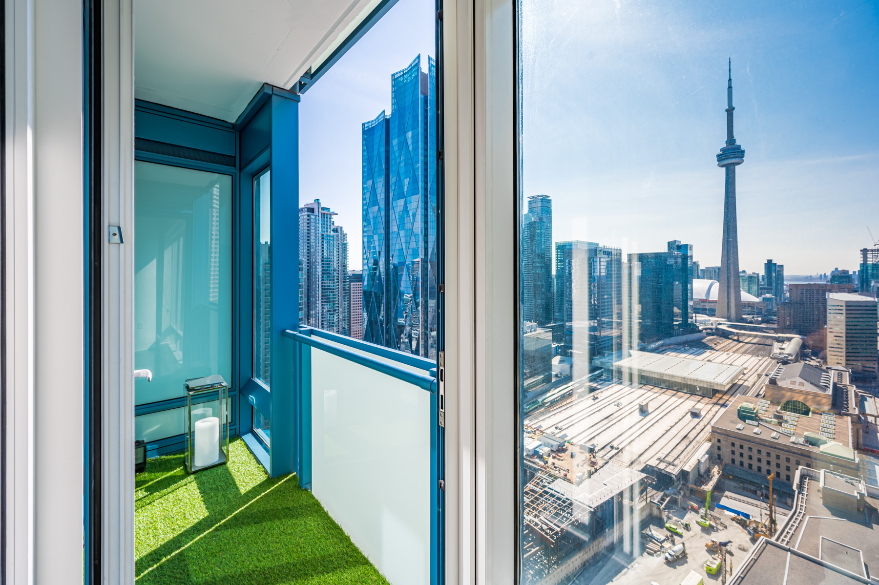 View of CN Tower through glass windows.