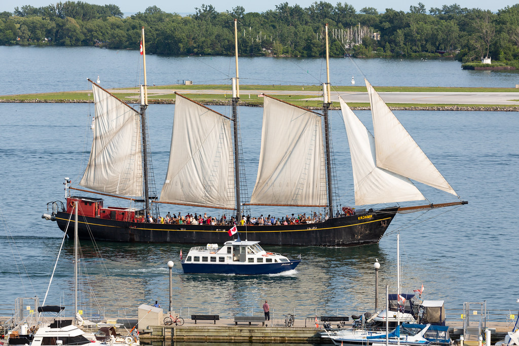 Old-fashioned tall-ship Kajama and small modern boat.