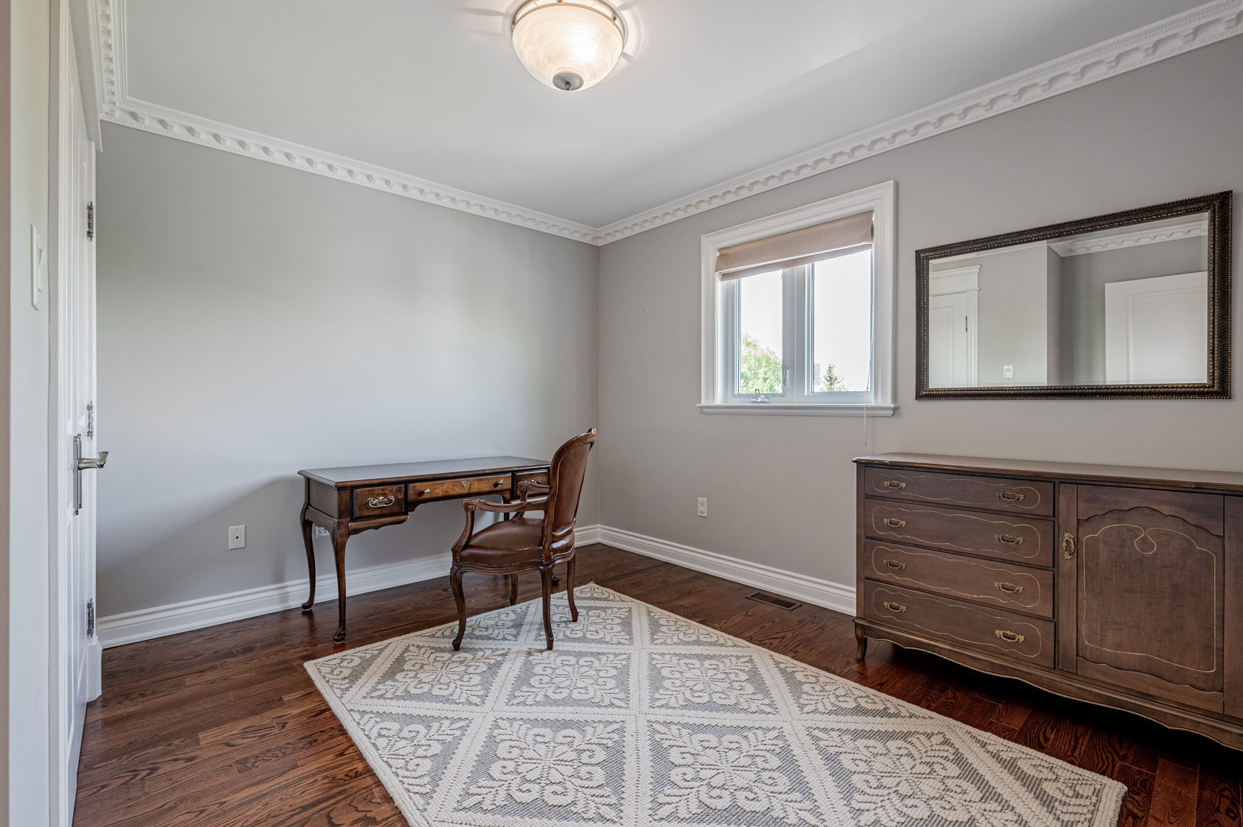 House bedroom with desk being used as study.