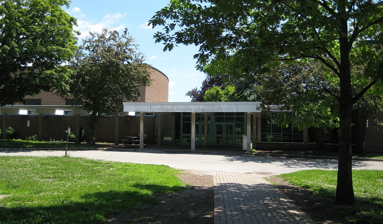 Facade and tree-lined path outside Rosedale Heights School of Arts in Toronto.