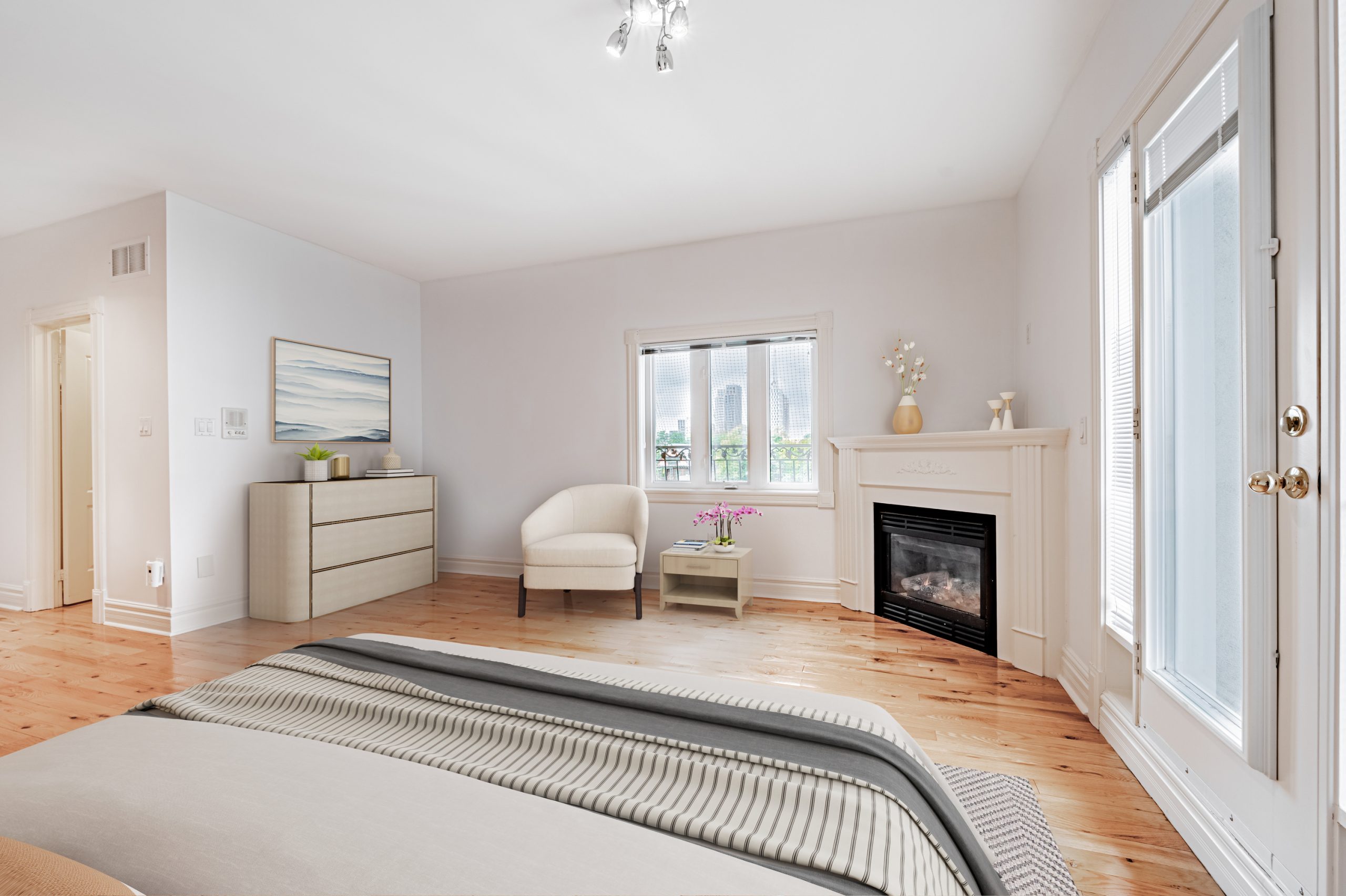 Bedroom with gas fireplace and Juliet balcony.