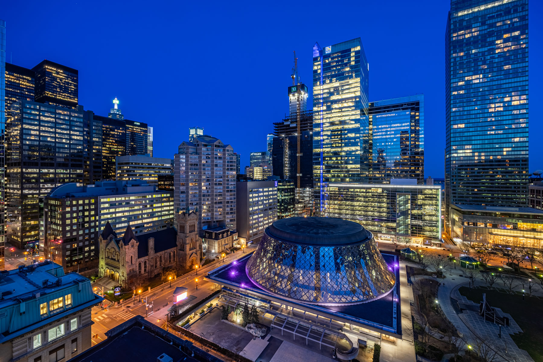 View of city lights at night from balcony of 224 King St W Unit 1504.