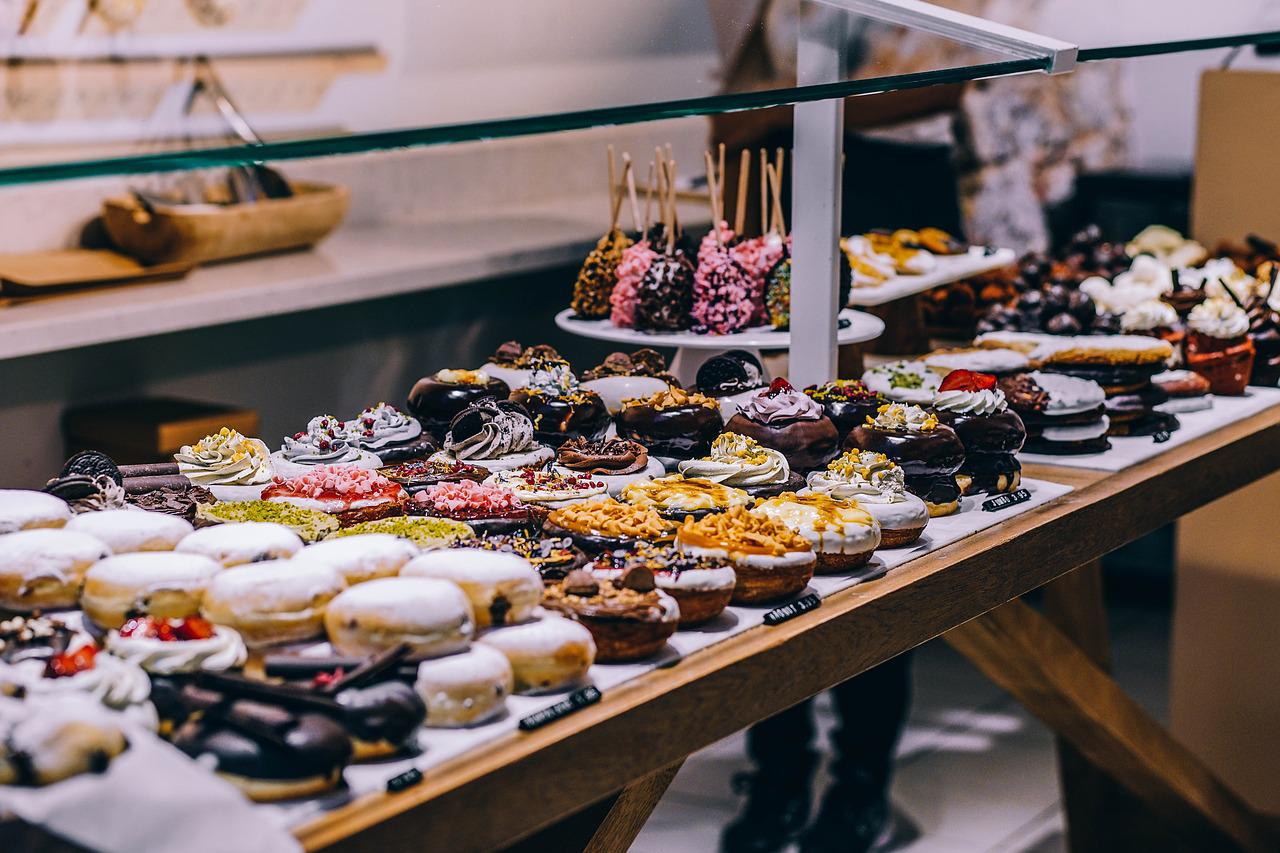 Bakery with donuts, cupcakes and other baked goods on display.