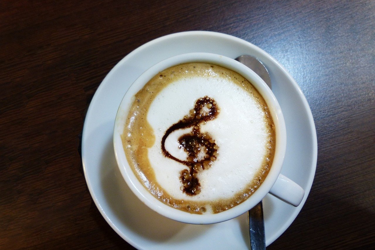 Cup of coffee decorated with chocolate musical note.