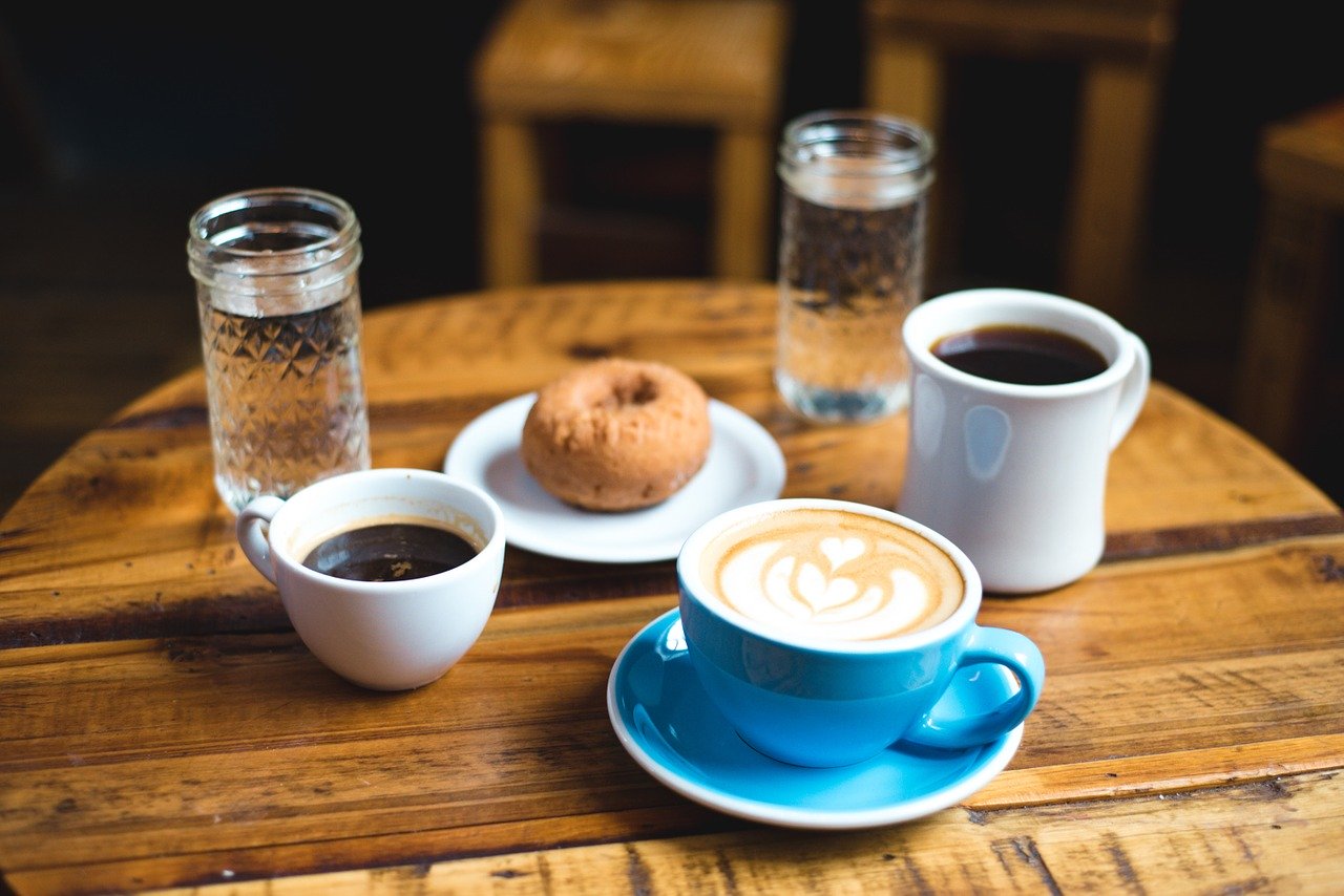 Table with coffee mug and bagel.