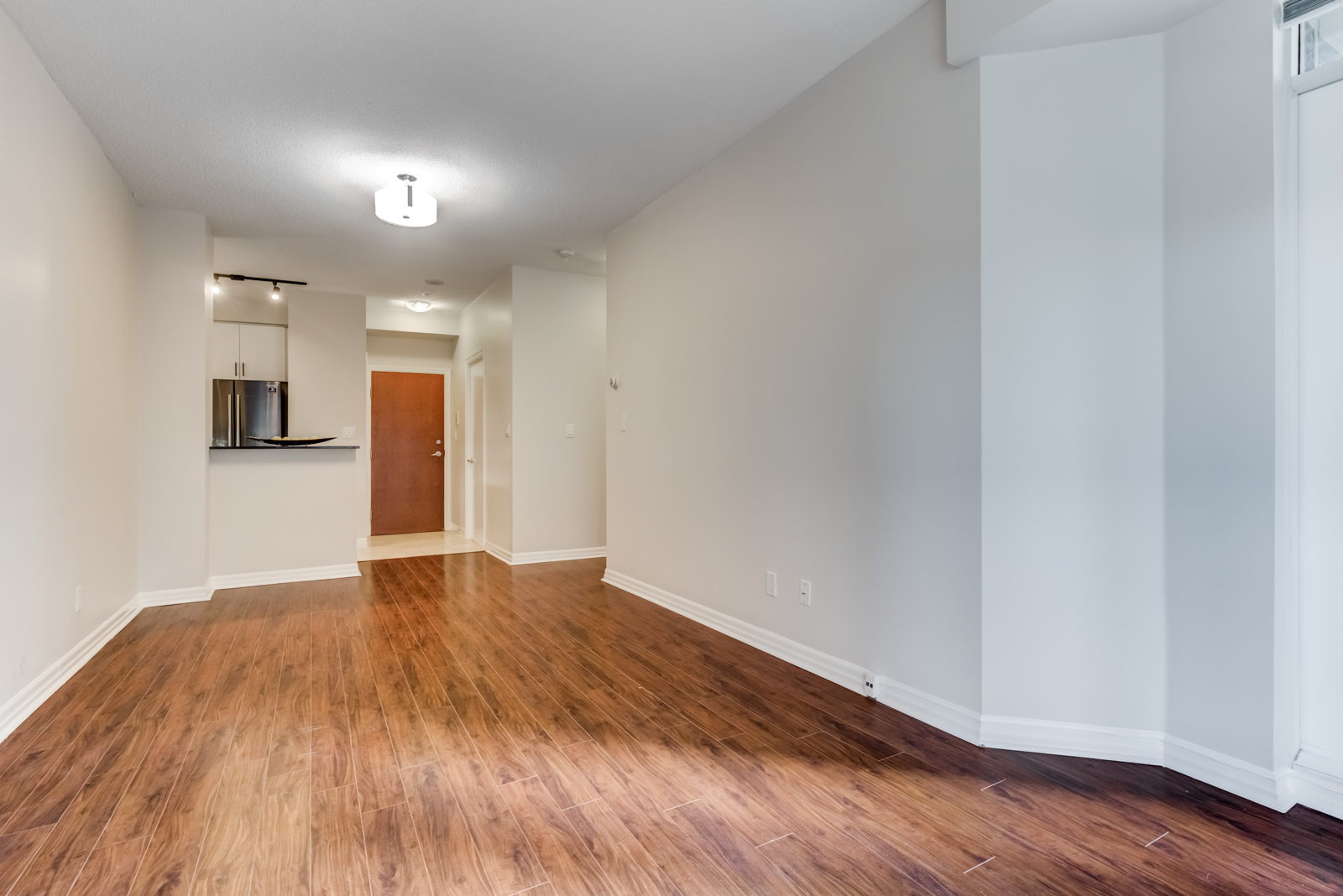 Empty condo living and dining room at 300 Bloor St E Suite 1809.