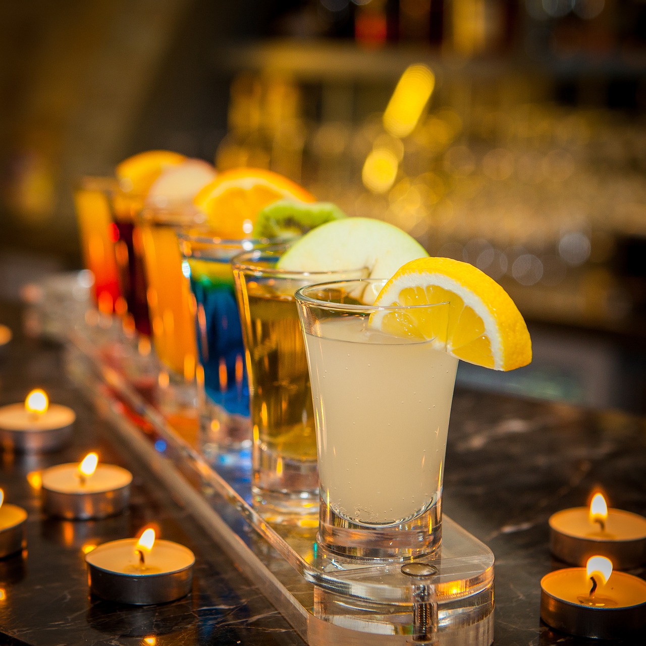 Colourful tequila shots arranged in row. 