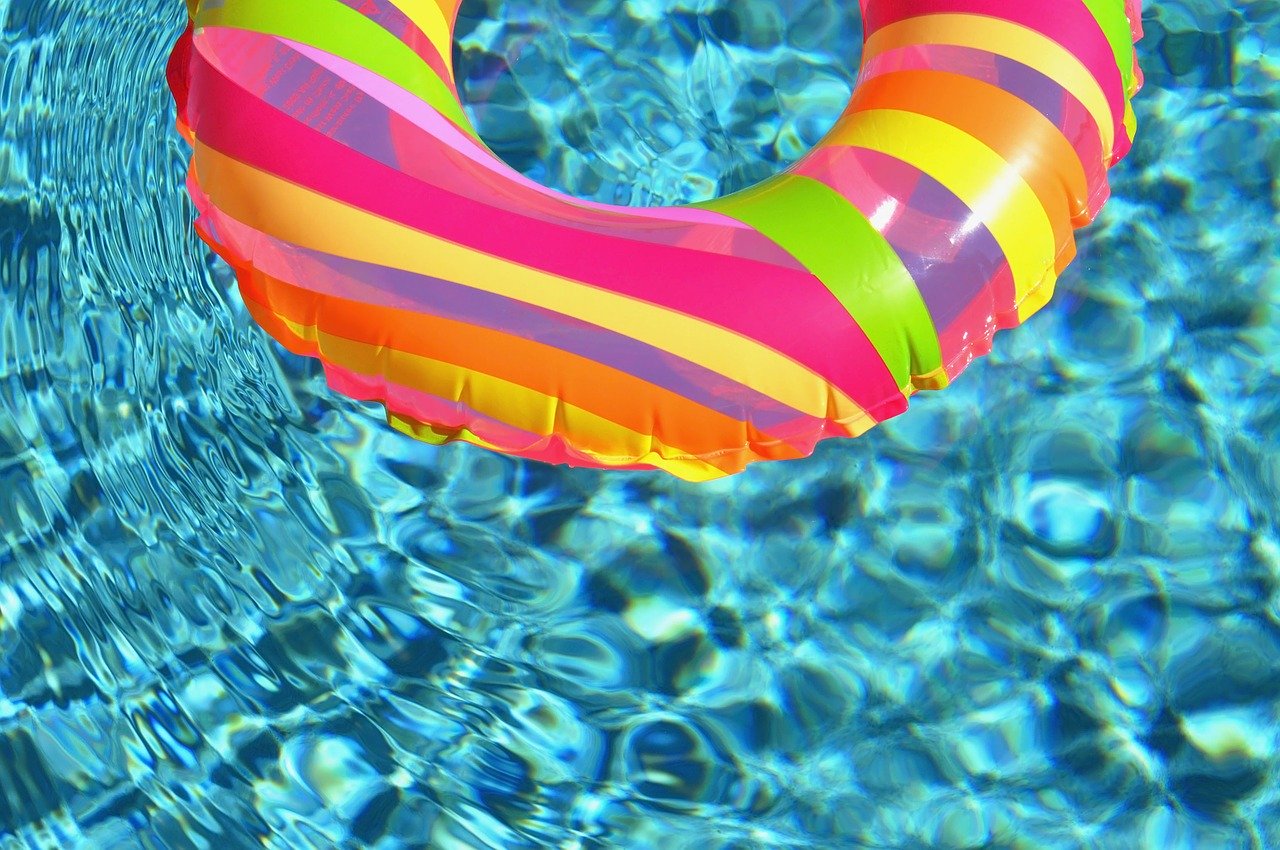 Close up of swimming pool with colourful flotation ring.