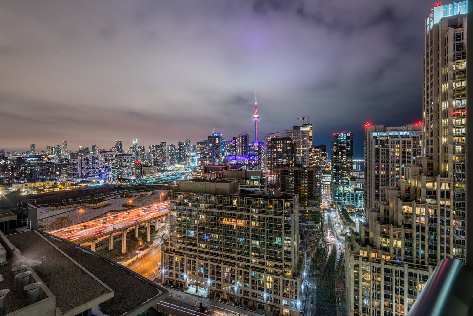 Night view of CN Tower, Downtown Toronto and Gardiner Expressway with colourful lights.