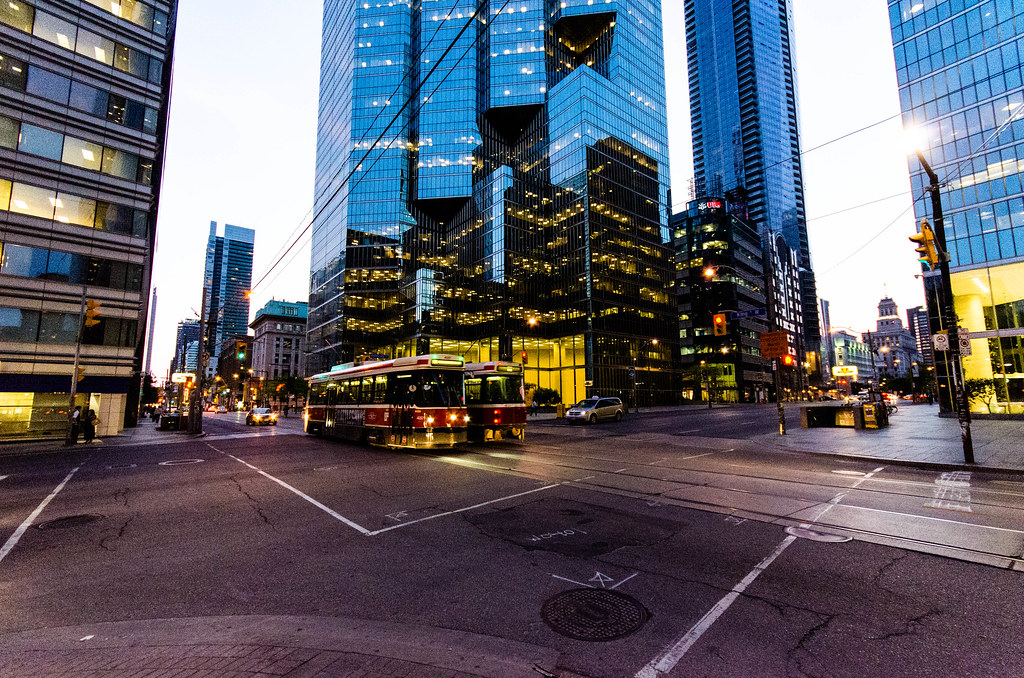 Two red and white streetcars in Toronto's Financial District.