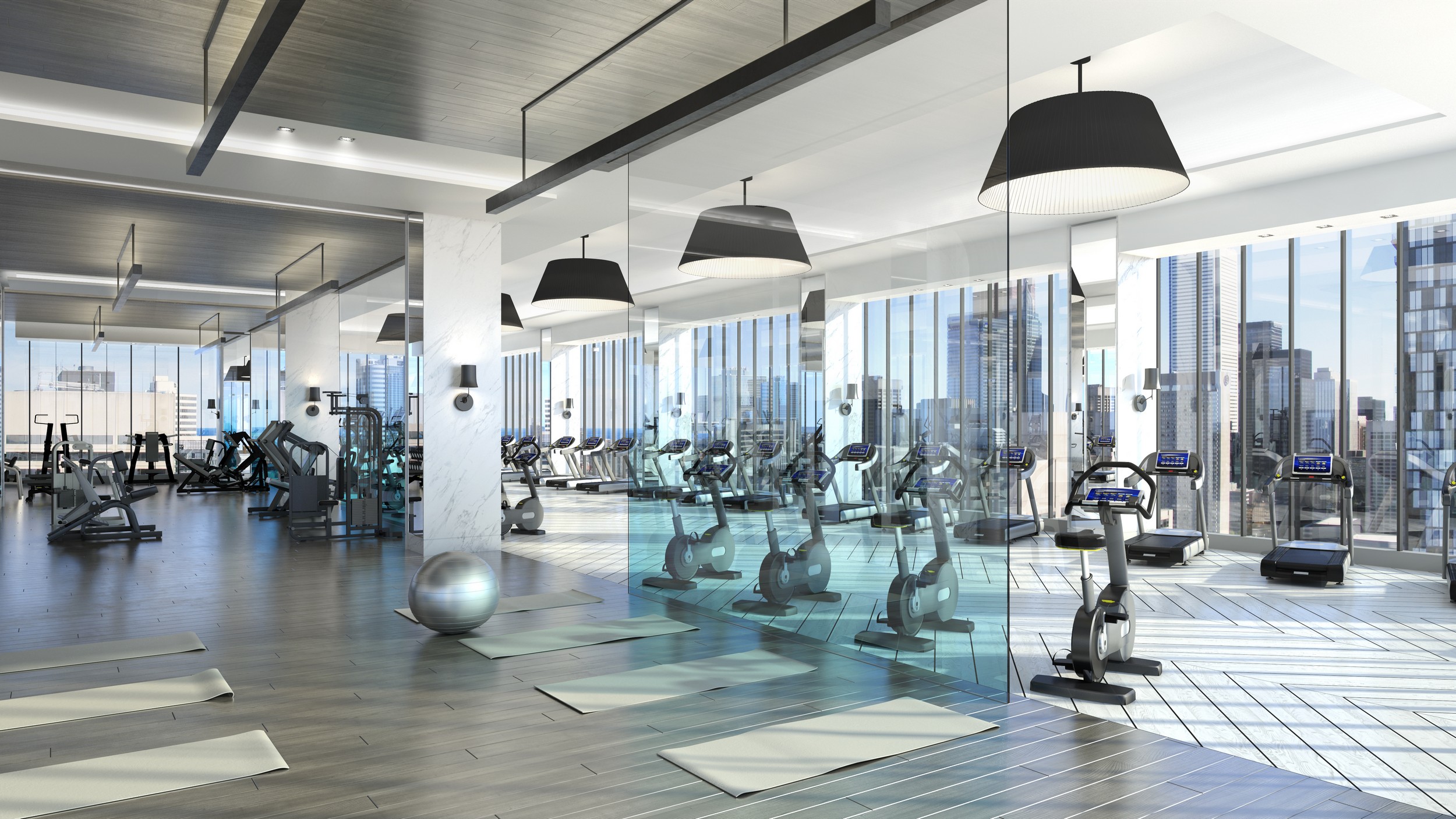 3d image of gym with exercise bikes, ball and yoga mats at The Residences of 488 University Avenue.