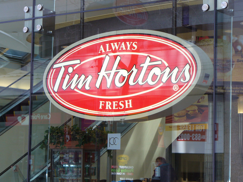 Large red and white Tim Hortons sign saying “Always Fresh.”