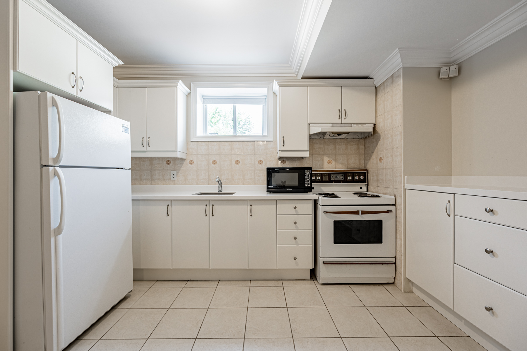 12 Highland Hill basement kitchen with tons of cabinets and window.